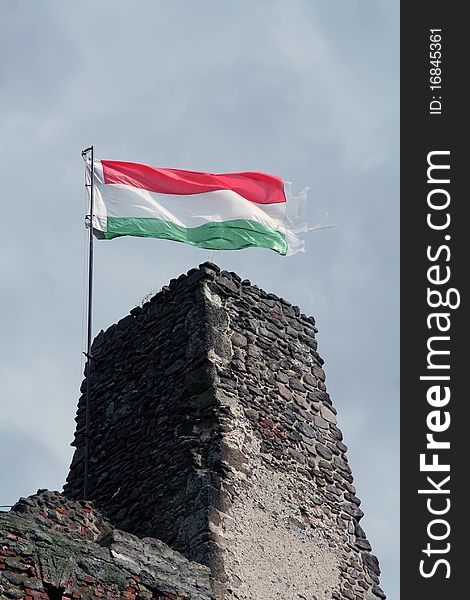 Flaming Hungarian flag on the ruins of an ancient castle. Boldogkővár, Hungary. Flaming Hungarian flag on the ruins of an ancient castle. Boldogkővár, Hungary.