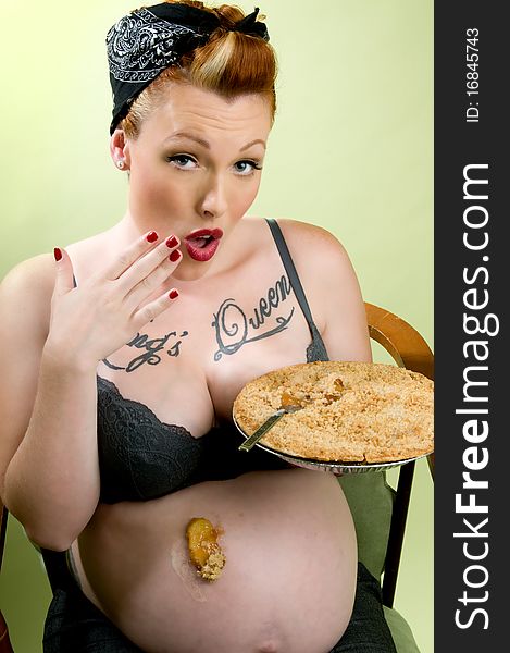 pregnant pinup model eating apple pie. pregnant pinup model eating apple pie
