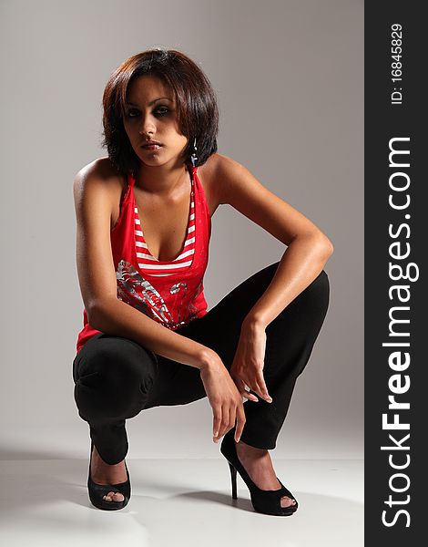 Beautiful Young Slim Girl Crouching In Studio