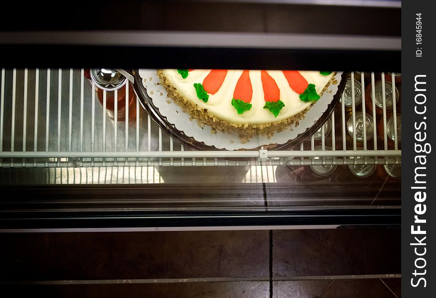 A carrot cake in a display case at a restaurant