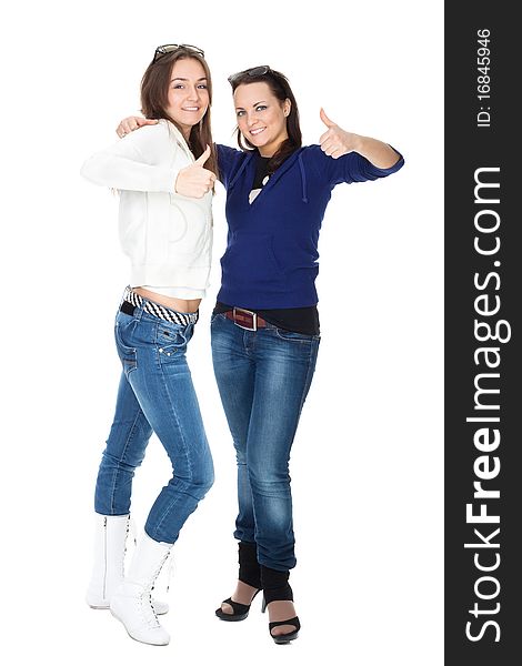 Two girls friends in jeans isolated on white