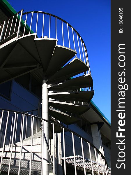 Image of a spiral staircase with blue sky background. Image of a spiral staircase with blue sky background