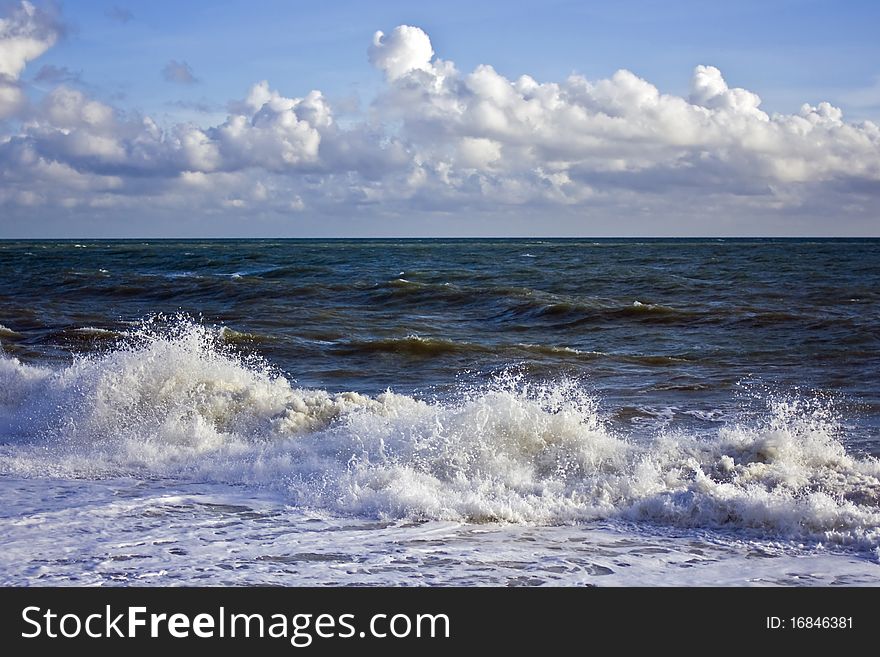 Waves crashing onto the shore on a wild and windy day. Waves crashing onto the shore on a wild and windy day