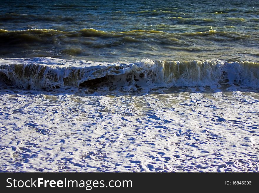 Waves crashing onto the shore on a wild and windy day