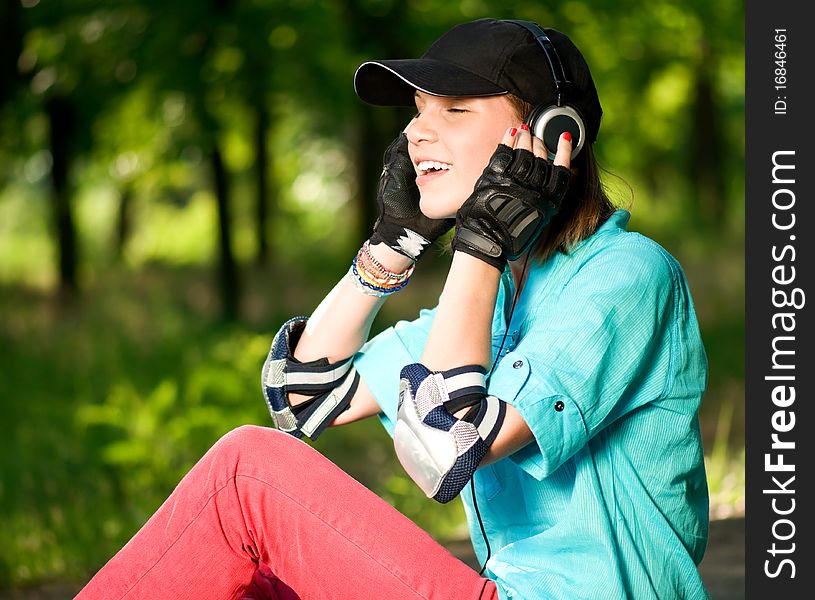 Beautiful teenage girl with headphones in the green park. Beautiful teenage girl with headphones in the green park