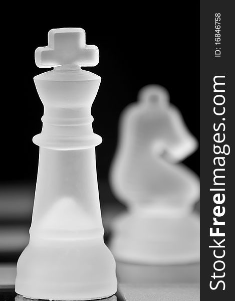 Beautiful chess pieces on black background with stunning color and definition