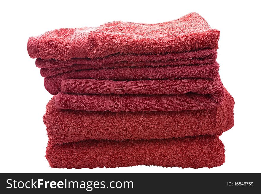 A stack of red bath towels against a white background