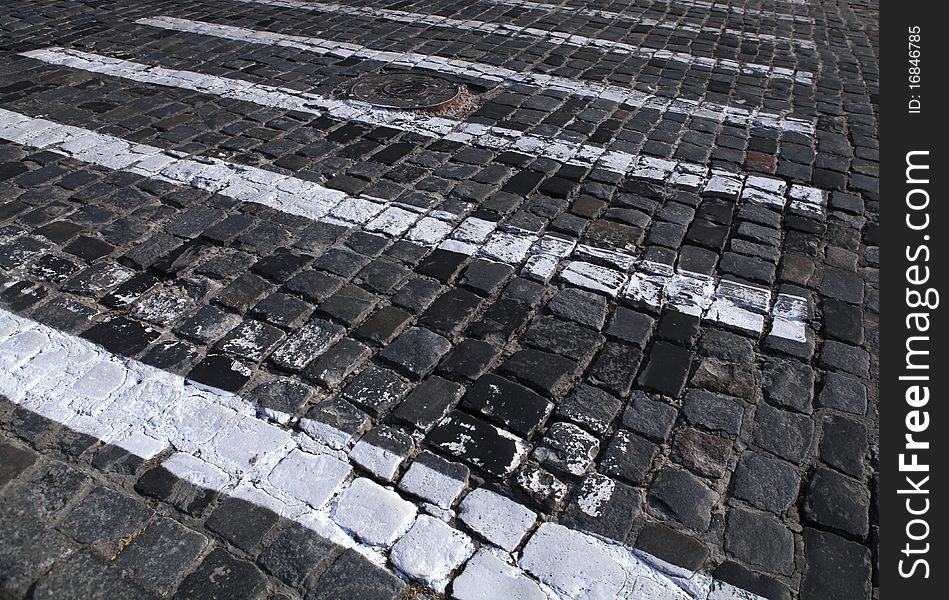 Paving stones texture with painted white pedestrian crossing