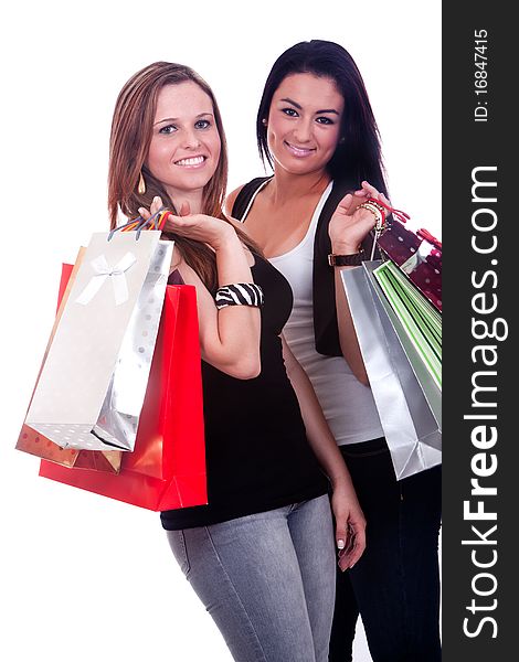 Two happy girls with shopping bags, isolated on a white background. Two happy girls with shopping bags, isolated on a white background.