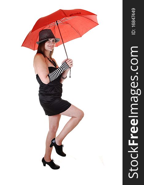 An middle aged woman in an short black dress and a gray hat standing
in the studio with a red umbrella in her hand. An middle aged woman in an short black dress and a gray hat standing
in the studio with a red umbrella in her hand.