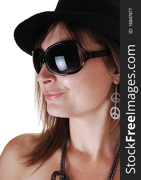 A closeup portrait of a middle aged woman with a black hat and big sunglasses a nice necklace and earrings, in profile. A closeup portrait of a middle aged woman with a black hat and big sunglasses a nice necklace and earrings, in profile.