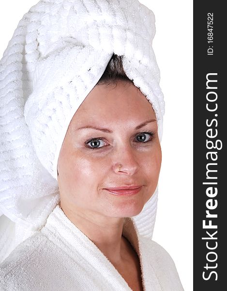 A middle aged woman in a white bathrobe and a towel around her hair
standing in the studio looking into the camera. A middle aged woman in a white bathrobe and a towel around her hair
standing in the studio looking into the camera.