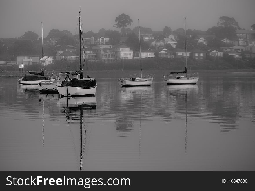 Yachts moored on glassy smooth water. Yachts moored on glassy smooth water.