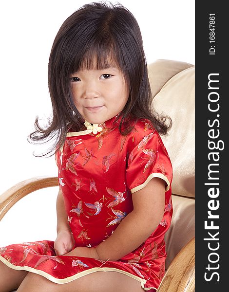 A young chinese girl is sitting in a chair. A young chinese girl is sitting in a chair.