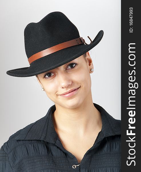 Portrait of the beautiful teenage girl wearing black cowboy hat. Portrait of the beautiful teenage girl wearing black cowboy hat.