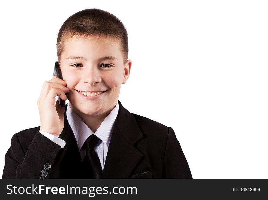 The boy speaks by phone, isolated on white