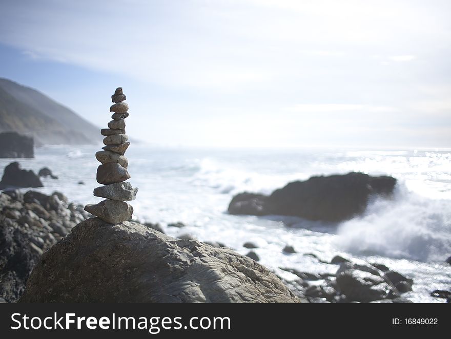 Stack of stones from larger to smaller with ocean in background. Stack of stones from larger to smaller with ocean in background