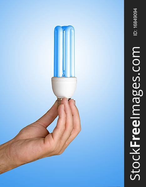 Hand holding an energy-saving lamp. Hand holding an energy-saving lamp