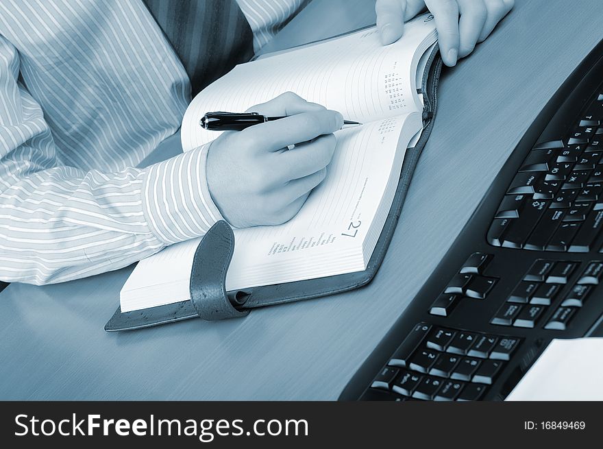 A young business man working in an office at his workplace.