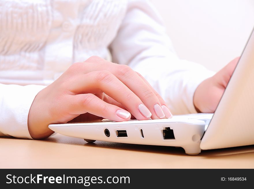 Hands of a young girl running on a computer in the office.