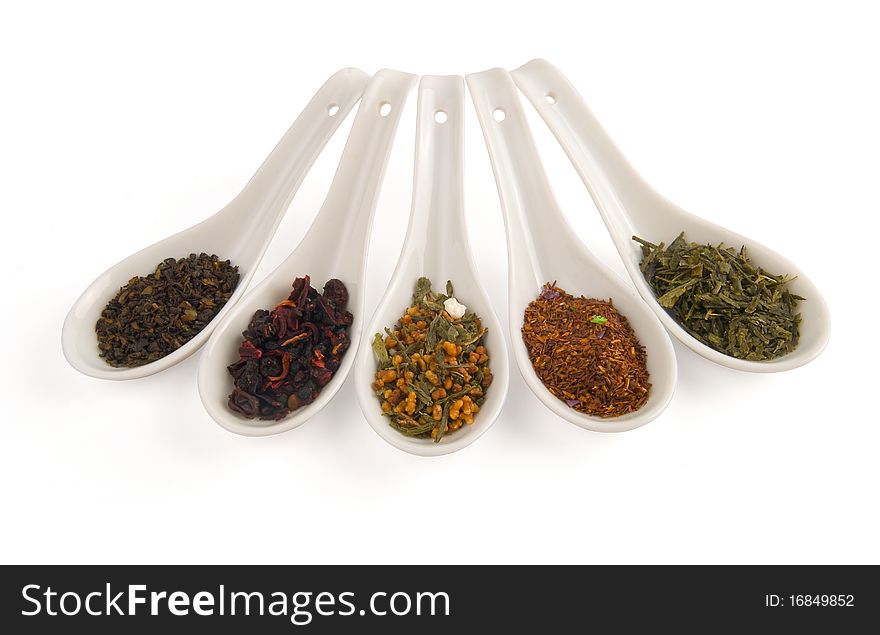 Chinese spoons with tea on white background.