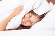 Morning At Home. Woman Lying On Bed Under Blanket Laughing Cheerful Close-up Royalty Free Stock Image