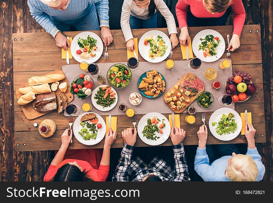 Every member of the big family eats. Festive table set for six people. Wooden background top view mock-up