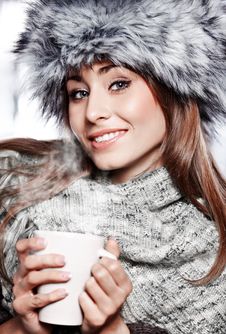 Girl Blowing On Hot Drink Royalty Free Stock Image