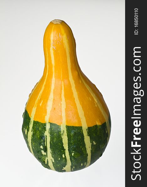 Close-up shoot of a yellow and green squash on white background.