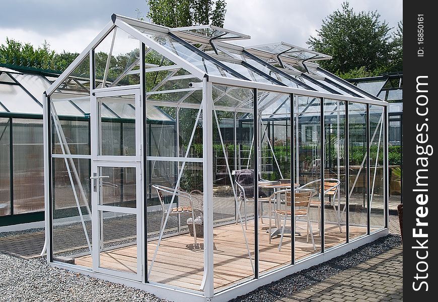 Formal garden glass pavilion with furniture