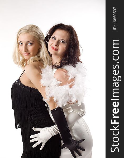 Two young woman in contrast white and black feather boa. Two young woman in contrast white and black feather boa
