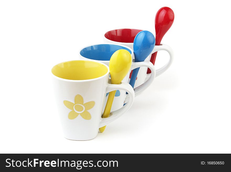 Colorful cups and spoons isolated on white background