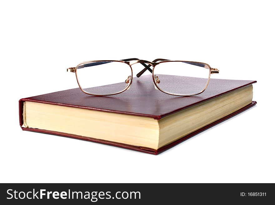 Book and glasses isolated on white background