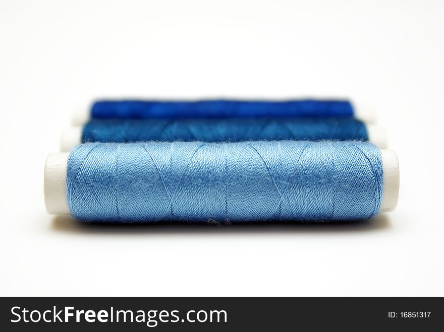 Blue threads isolated on white background