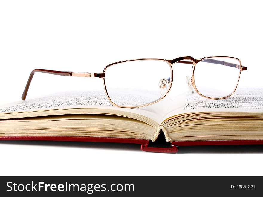 Book and glasses isolated on white background