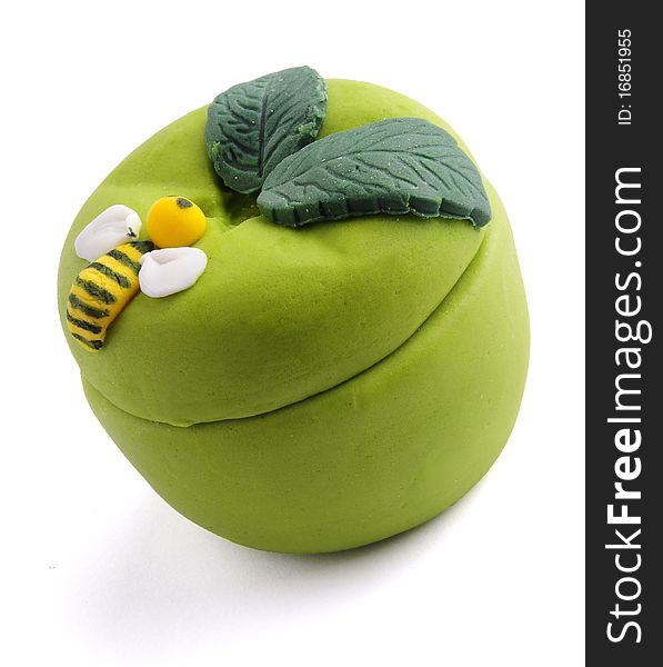 A green Sugar Dough box. with some leaves and a bee on it.