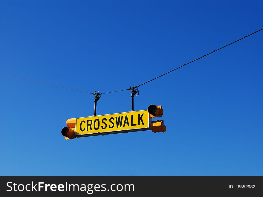 Crosswalk sign in front of a school