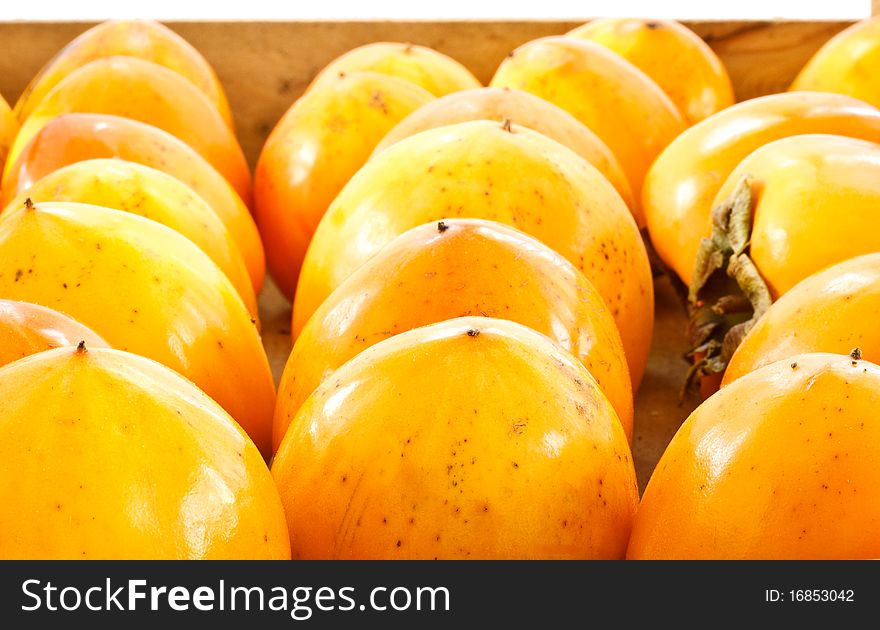 A lot of persimmons folded into a box before selling