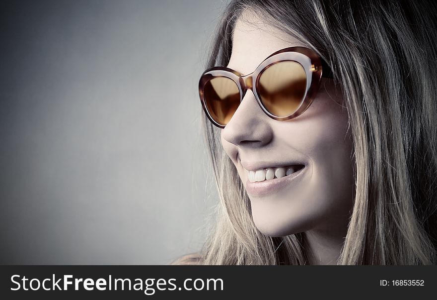 Smiling beautiful woman wearing sunglasses. Smiling beautiful woman wearing sunglasses