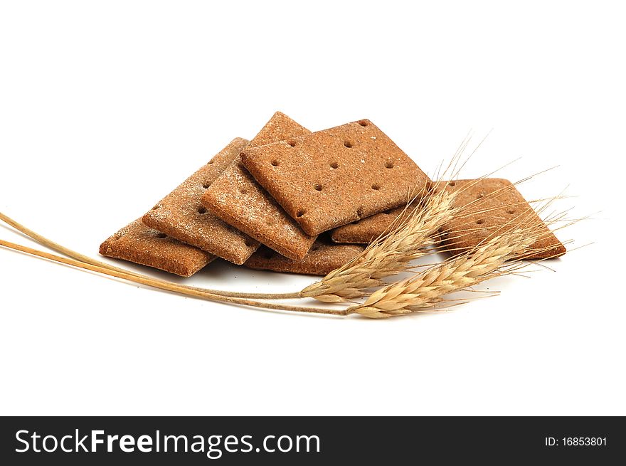 Stack of cracker slices for balance diet and wheat on white background