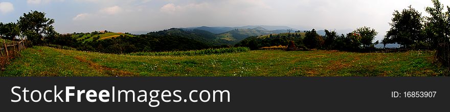 A panoramic image taken from the top of a mountain in Romania, near a village called Ravensca.