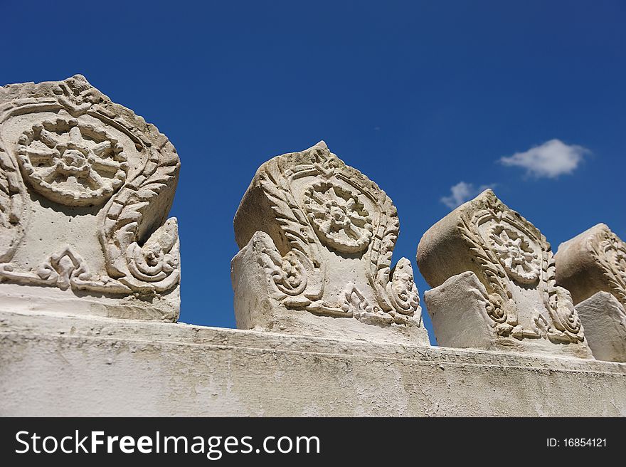 Wall of Buddhist Temple against blue sky