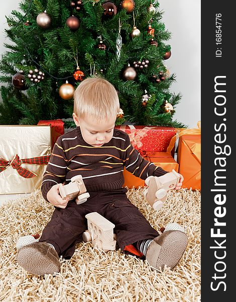 Baby boy playing with a toy engine at christmas. Baby boy playing with a toy engine at christmas