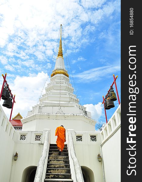 Buddhist monk walks through the gateway of Wat. Buddhist monk walks through the gateway of Wat