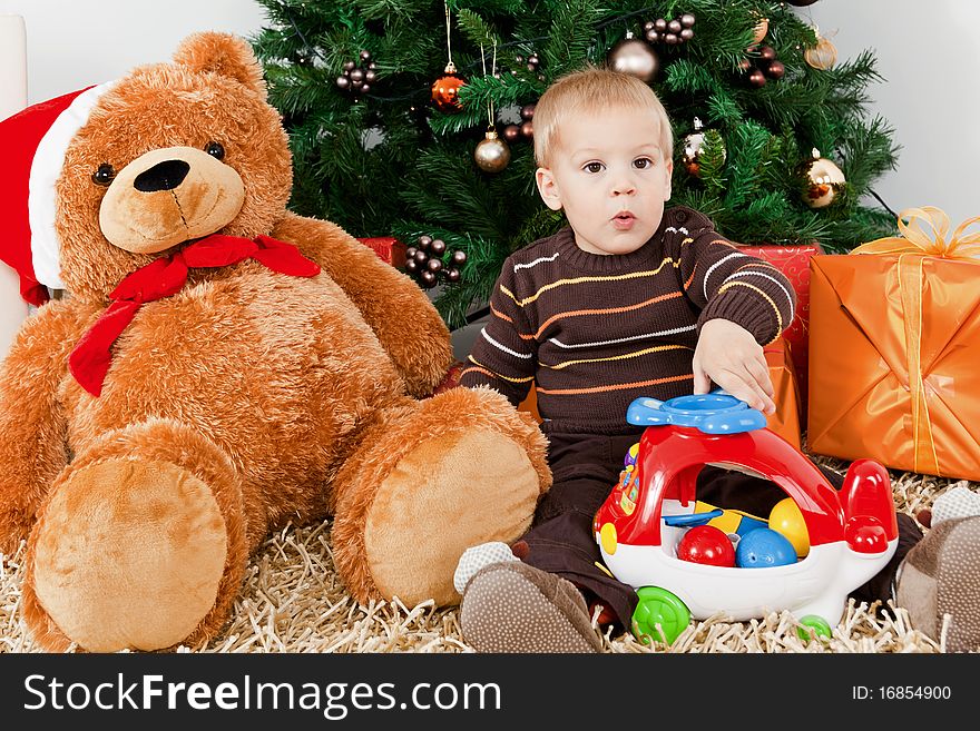 Baby boy discerning santa klaus at christmas at home