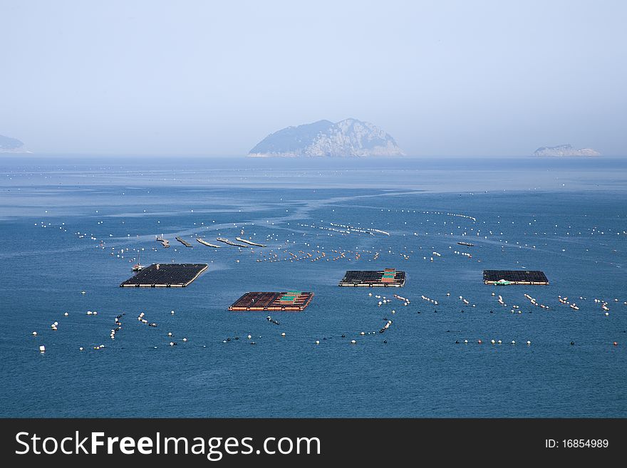 Wide view of fishing farm on calm ocean