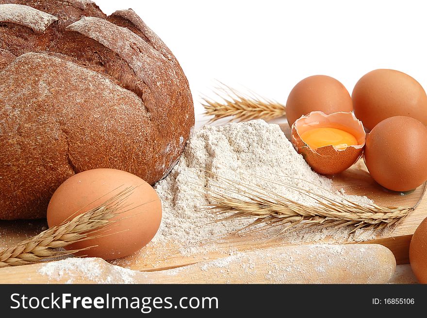 Homemade whole bread and flour on a white background. Homemade whole bread and flour on a white background