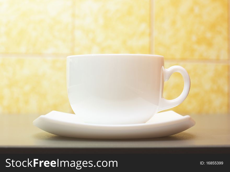 White cup of tea over kitchen table