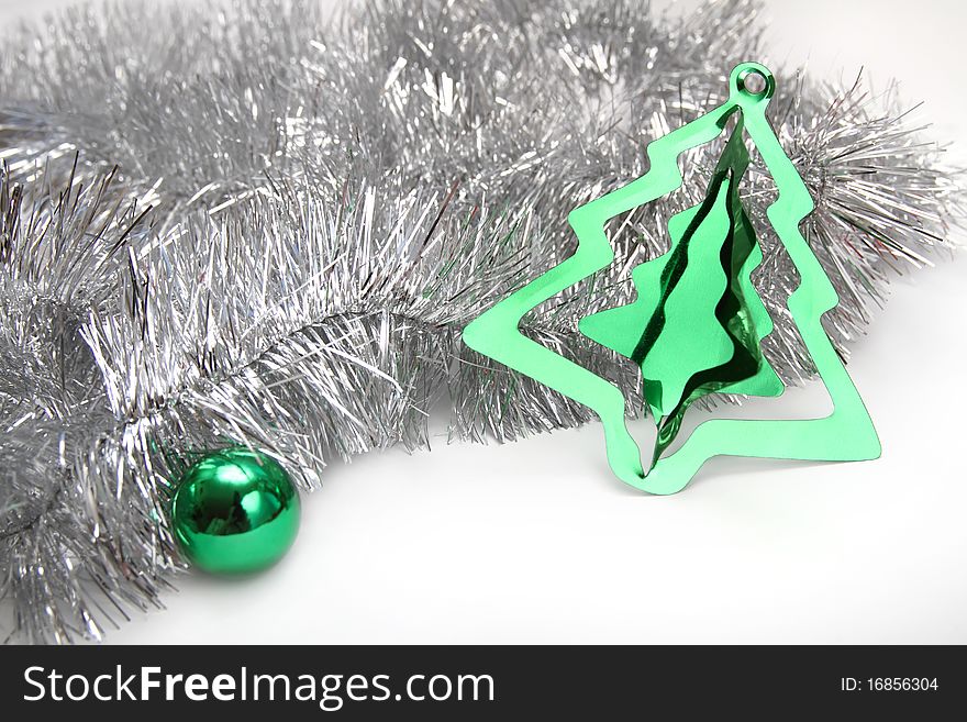 Christmas background with silver tinsel, green sphere and stylish cristmas tree decoration. Christmas background with silver tinsel, green sphere and stylish cristmas tree decoration