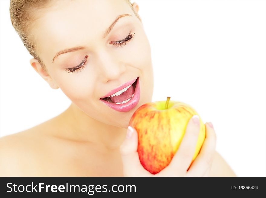 Attractive girl eats an apple isolated on white background